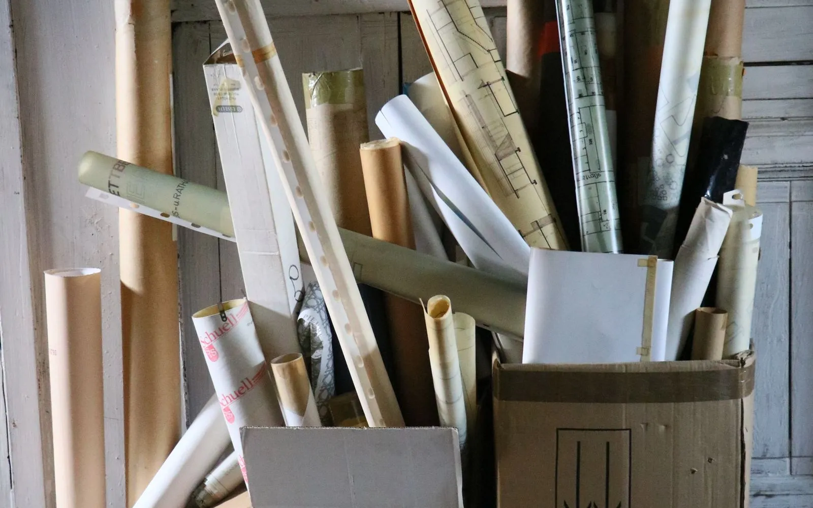 Boxes crammed with rolled-up paper plans