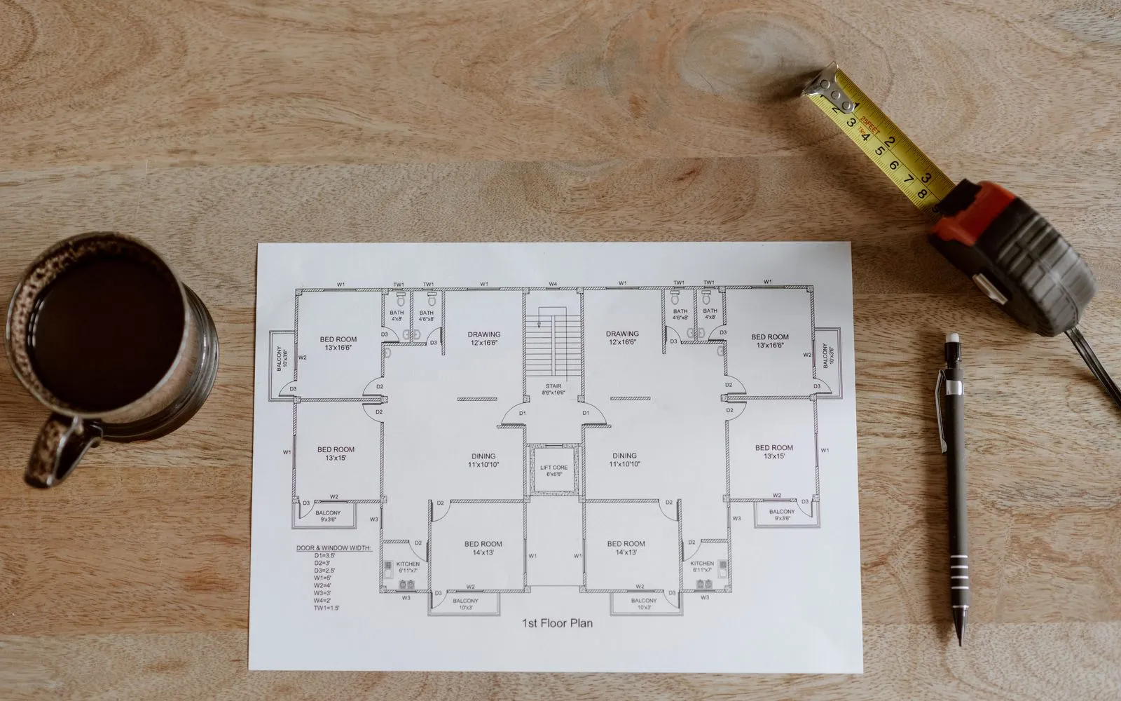 A printed floor plan measured with a tape measure and pencil